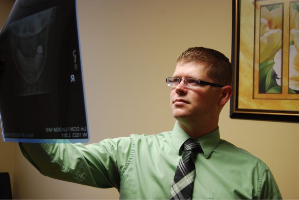 Dr. Reece Hayden reviewing a cervical (neck) x-ray at Synergy Chiropractic of Houston